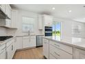This kitchen has modern appliances and fixtures, plenty of natural light, and a practical kitchen island at 6681 Michael Favor Way, Wesley Chapel, FL 33545