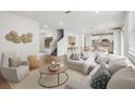 Bright, open-concept living room featuring hardwood floors and modern decor at 6681 Michael Favor Way, Wesley Chapel, FL 33545
