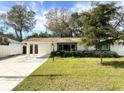 Newly renovated home with a spacious driveway and well-manicured lawn at 2600 Robinson Ave, Sarasota, FL 34232