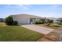 White house with attached garage and well-manicured lawn at 1630 Bentwood Dr, Sun City Center, FL 33573