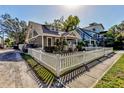 Charming craftsman home with white picket fence, well-manicured lawn at 615 Grove N St, St Petersburg, FL 33701