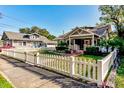 Charming gray house with a white picket fence at 615 Grove N St, St Petersburg, FL 33701