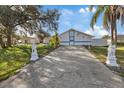 House exterior with long driveway and landscaping at 12174 Laramore St, Spring Hill, FL 34608