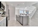Modern kitchen with island, stainless steel appliances, and white cabinets at 31873 Anchor Point Dr, Wesley Chapel, FL 33545
