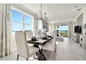 Bright dining room with large windows and stylish dining set at 31873 Anchor Point Dr, Wesley Chapel, FL 33545