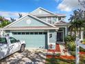 Two-story house with a two-car garage and landscaped yard at 5009 Clover Mist Dr, Apollo Beach, FL 33572
