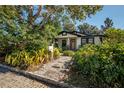 Charming bungalow exterior with a landscaped front yard and porch at 6701 N Branch Ave, Tampa, FL 33604