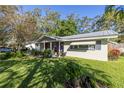 Bright, single story home with a spacious front yard and metal roof at 1960 Alton Dr, Clearwater, FL 33763