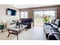 Bright living room with sliding glass doors and patio access at 7518 Lyncrest St, North Port, FL 34287