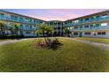Evening exterior view of mid-century modern building with landscaping at 1950 59Th N Ave # 318, St Petersburg, FL 33714