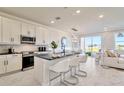 Open concept kitchen with white cabinets, large island, and stainless steel appliances at 31885 Anchor Point Dr, Wesley Chapel, FL 33545