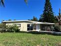 Ranch style home with carport and mature lawn at 5323 Carlton Rd, New Port Richey, FL 34652