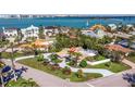 Aerial view of waterfront home with lush greenery, screened-in porch, and convenient access to the bay at 165 4Th N Ave, Tierra Verde, FL 33715