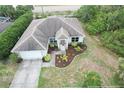 A single-story home showcasing well-kept landscaping, a neutral paint scheme and an attached two-car garage at 2857 Brewster Rd, North Port, FL 34288