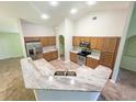 The kitchen features a spacious island, tile floors, stainless steel appliances and light-colored cabinets at 2857 Brewster Rd, North Port, FL 34288