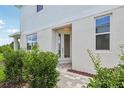 Inviting front entrance with well-maintained landscaping, pathway and white door at 31895 Anchor Point Dr, Wesley Chapel, FL 33545