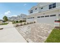 Charming two-story townhome with two-car garage and a well manicured lawn and blue skies at 31895 Anchor Point Dr, Wesley Chapel, FL 33545