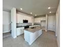 Modern kitchen with white cabinets, stainless steel appliances, and granite countertops at 31895 Anchor Point Dr, Wesley Chapel, FL 33545