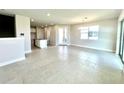 Spacious living room with tile floors, large windows, and a view of the kitchen at 31895 Anchor Point Dr, Wesley Chapel, FL 33545