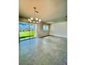 Spacious dining room area with tile flooring and sliding glass doors to the backyard at 31901 Anchor Point Dr, Wesley Chapel, FL 33545