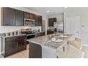 Modern kitchen with dark wood cabinets and granite countertops at 35569 Sunflower Hill Dr, Zephyrhills, FL 33541