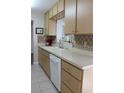 Kitchen with light wood cabinets and a double sink at 4460 95Th N Ave # 1, Pinellas Park, FL 33782
