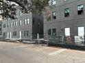 Dark gray brick townhomes under construction, modern design at 1218 E Kay St # 2, Tampa, FL 33602