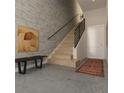 Modern entryway with wood staircase and accent wall at 1302 E Kay St # 1, Tampa, FL 33602