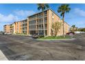 Two-story condo building with ample parking and lush landscaping at 12760 Indian Rocks Rd # 1071, Largo, FL 33774