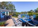 Brick patio with fire pit and outdoor dining set at 10931 Clara Ln, St Petersburg, FL 33708