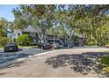 Parking lot with several cars parked in front of two story building at 2101 Fox Chase Blvd # 106, Palm Harbor, FL 34683