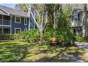 Landscaped courtyard with a wooden bench, surrounded by two story buildings at 2101 Fox Chase Blvd # 106, Palm Harbor, FL 34683