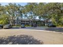 Parking area in front of two story building with many trees at 2101 Fox Chase Blvd # 106, Palm Harbor, FL 34683