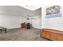Open living room with wood-look floors, featuring a small table and chairs at 8378 Gibralter St, Spring Hill, FL 34608