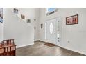 Bright entryway with wood-look floors, featuring a bench and Gathering photos at 8378 Gibralter St, Spring Hill, FL 34608
