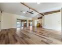 Spacious living room featuring hardwood floors and a high ceiling with exposed beams at 10520 Collar Dr, San Antonio, FL 33576