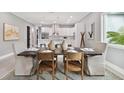 Elegant dining room features a dark wood table and neutral colored chairs at 2921 Sanchez St, Tampa, FL 33605