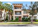 Charming three-story townhome with dual balconies, landscaped yard, and inviting curb appeal in a serene neighborhood at 5902 Yeats Manor Dr, Tampa, FL 33616
