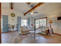 Relaxing living room with hardwood floors and wood beamed ceiling at 1106 Oxbow Rd, Wimauma, FL 33598