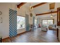 Spacious living room with vaulted ceiling, hardwood floors, and large windows at 1106 Oxbow Rd, Wimauma, FL 33598