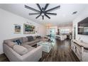 Spacious living room with L-shaped sectional sofa and kitchen views at 2444 Foggy Creek Cir, Clearwater, FL 33764