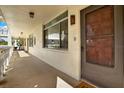 Residential hallway leading to condo unit, featuring tiled floors and neutral walls at 1012 Pearce Dr # 209, Clearwater, FL 33764