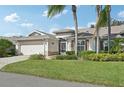 Charming single-story home with a two-car garage and manicured lawn at 1232 Corinth Greens Dr, Sun City Center, FL 33573