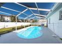 Inviting kidney-shaped swimming pool with screened enclosure at 2721 Bora Bora Pl, Holiday, FL 34691