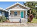 Updated bungalow exterior, featuring a teal front door at 1325 W North B St, Tampa, FL 33606
