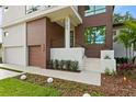 Modern house exterior with a wooden accent wall at 5104 W Evelyn Dr, Tampa, FL 33609
