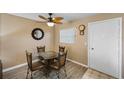 Small dining area with glass table and four chairs at 2750 E Bay Dr # 5F, Largo, FL 33771