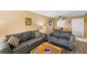 Living room with gray sofas, coffee table, and wood-look floors at 2750 E Bay Dr # 5F, Largo, FL 33771