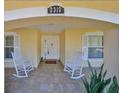 Front porch with two rocking chairs and a welcoming entrance to the house at 2313 Towering Oaks Cir, Seffner, FL 33584