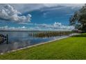 Scenic view of a peaceful lake with lush green grass at 90 S Highland Ave # 1115, Tarpon Springs, FL 34689